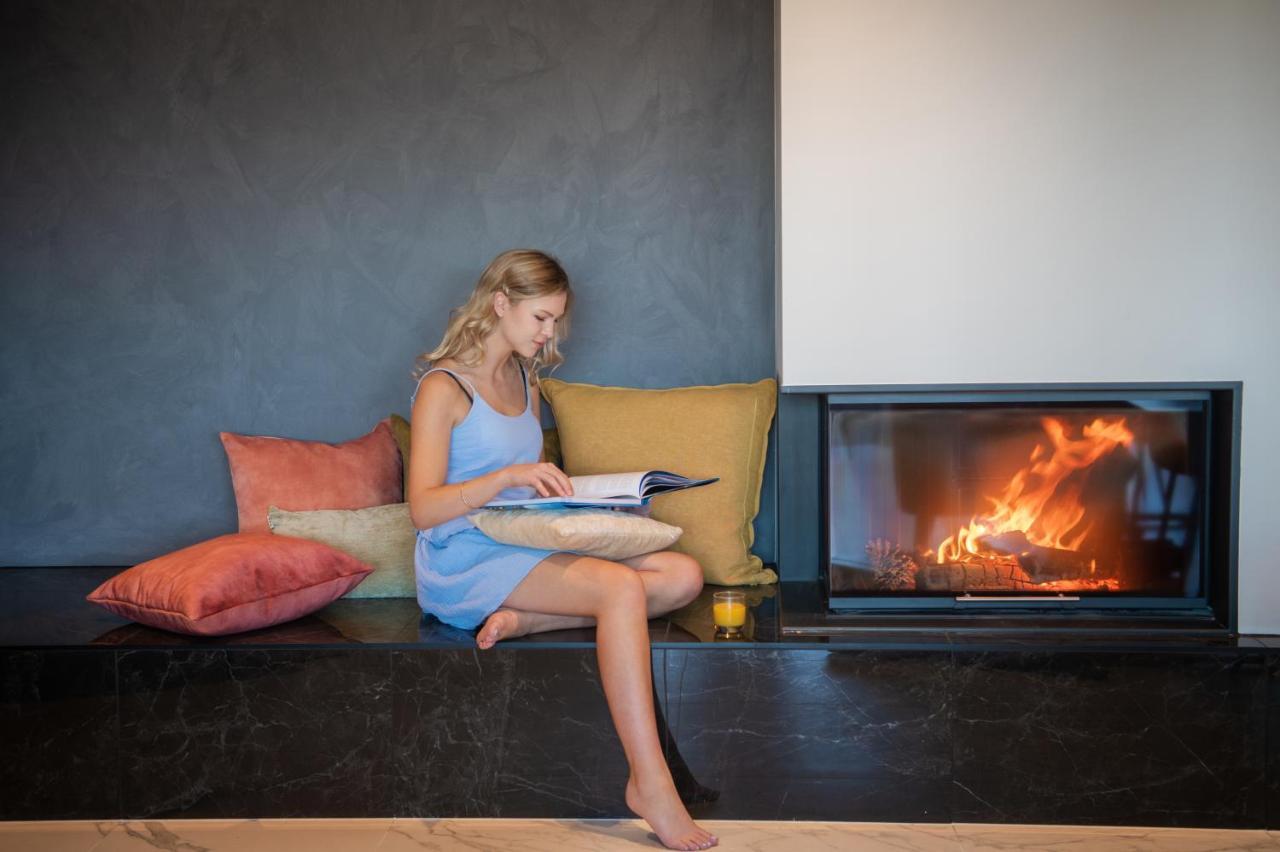 Galaxy Boutique Hotel Lake Tekapo Exterior photo A woman reading a book by a fireplace